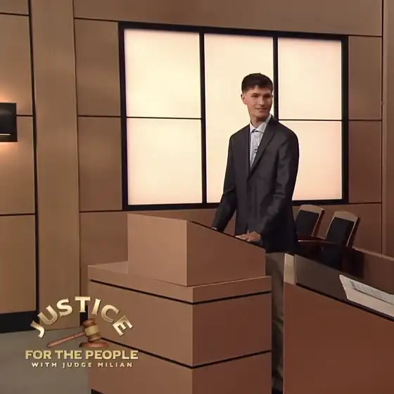 Matt standing at a courtroom set podium.