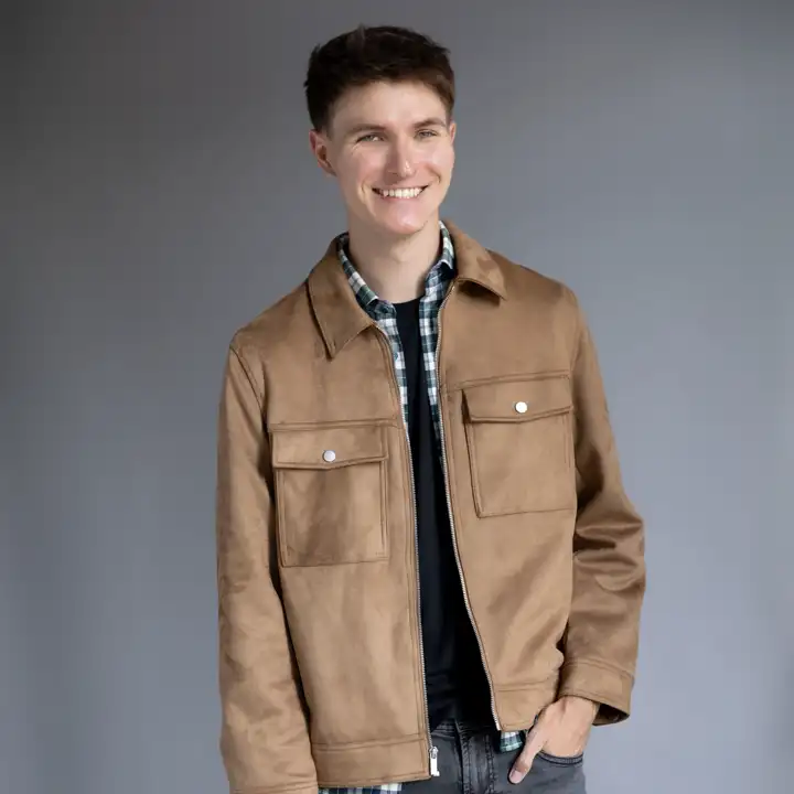 Matt smiling in a tan jacket.