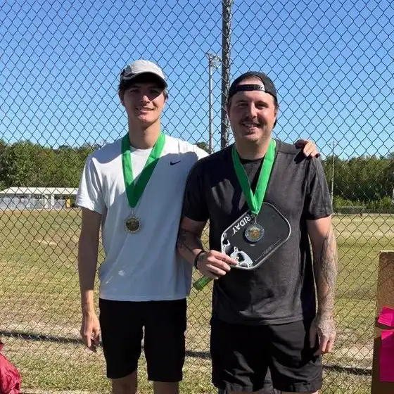 Matt and a teammate with pickleball medals.